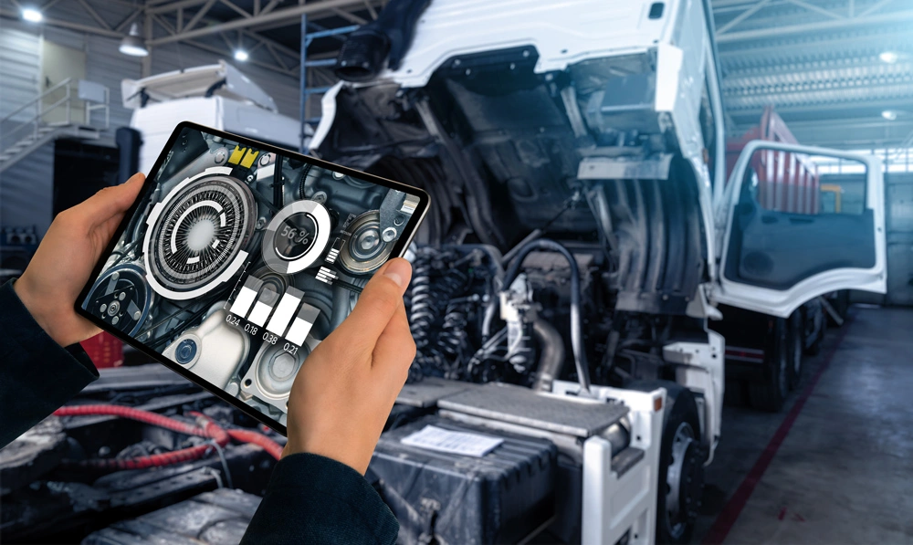 Serviceman repairing a truck using augmented reality application.